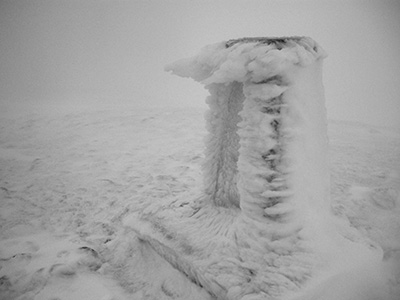 Rime growing out of a Trig point. The wind direction is from the left of the picture